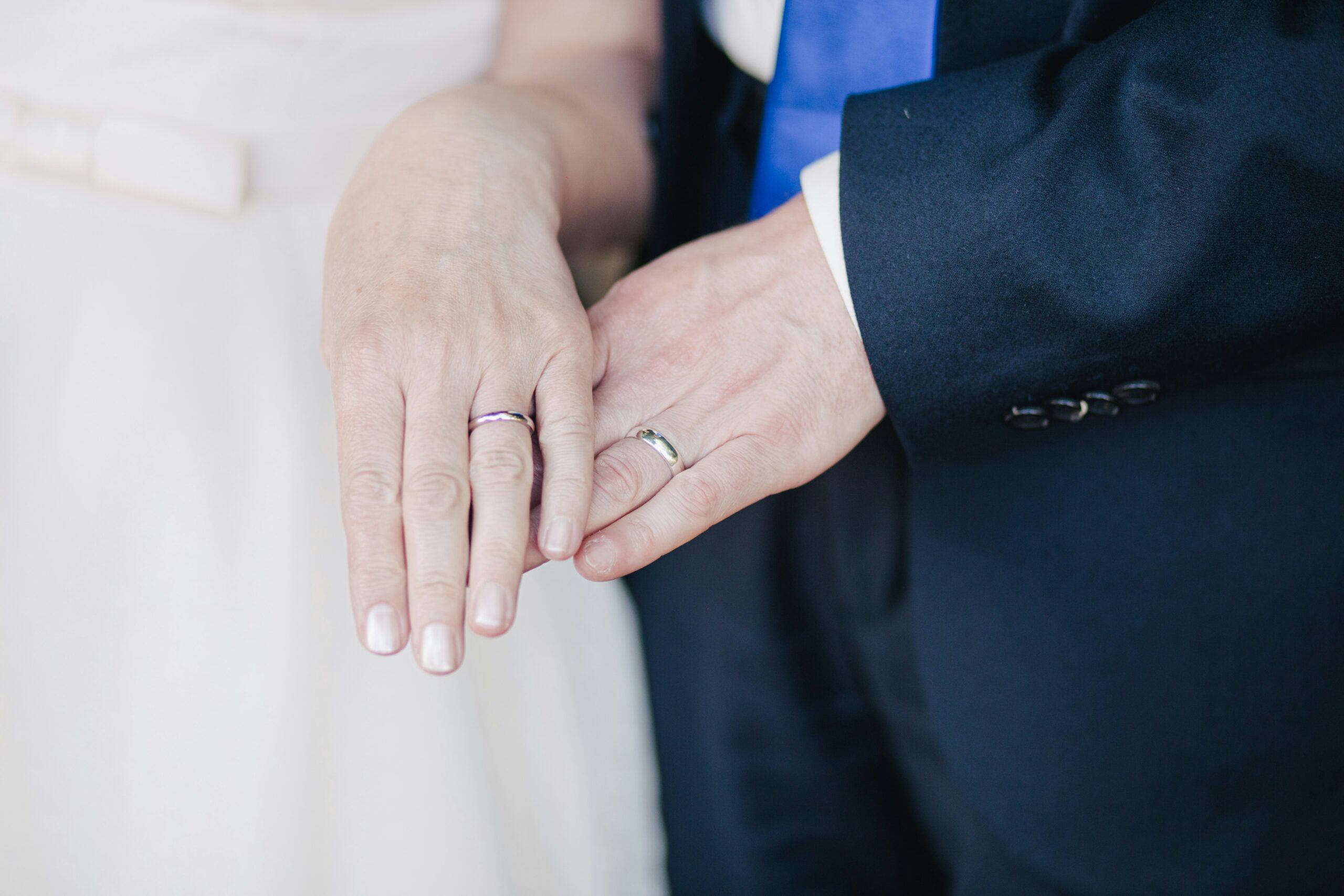 couple wearing their band rings